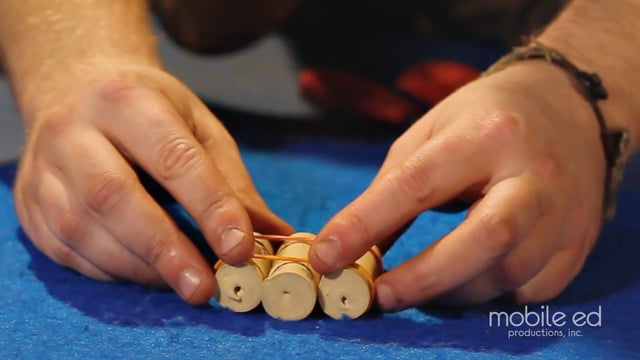 Spread the rubber bands to the ends of the corks | Handy Dan the Junkyard Man | Mobile Ed Productions