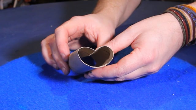 Press on the cardboard tube to shape it into a heart shape
