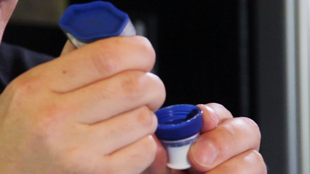 Apply a thick bead of glue to the inside edge of the sports bottle cap